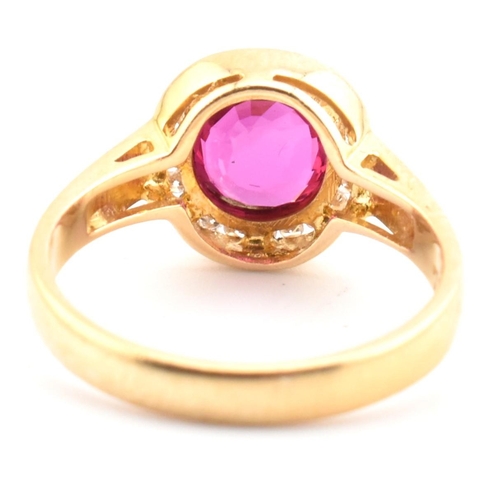 21 - An 18ct gold, ruby and diamond cluster ring with certificate. The 18ct yellow gold cluster ring havi... 