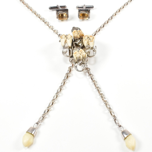 216 - A vintage hunt necklace set with animal teeth and a pair of silver and citrine cufflinks. The Jagdsc... 