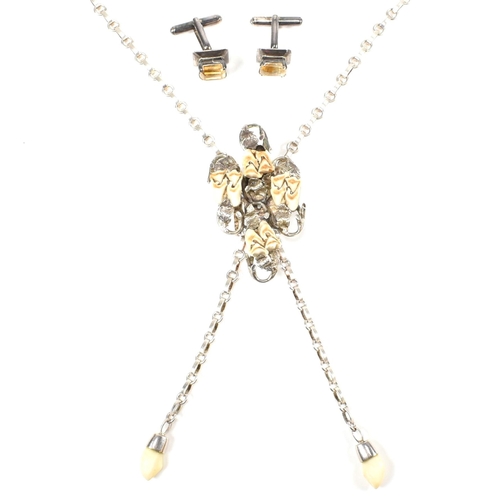 216 - A vintage hunt necklace set with animal teeth and a pair of silver and citrine cufflinks. The Jagdsc... 