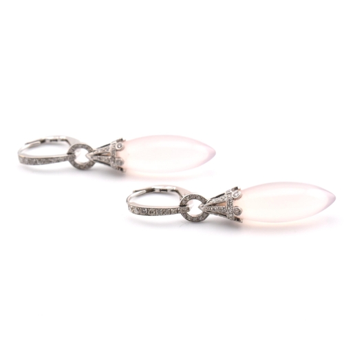 22 - A pair of 18ct white gold, rose quartz and diamond pendant earrings. The pendant earrings having a s... 