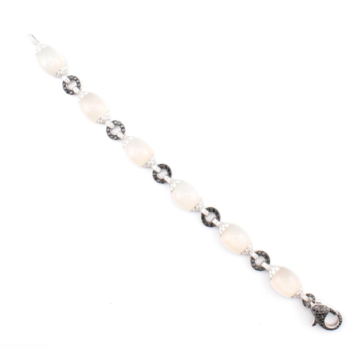 30 - An 18ct white gold, chalcedony and diamond panel bracelet. The 18ct white gold bracelet having point... 