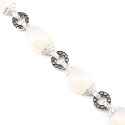 30 - An 18ct white gold, chalcedony and diamond panel bracelet. The 18ct white gold bracelet having point... 