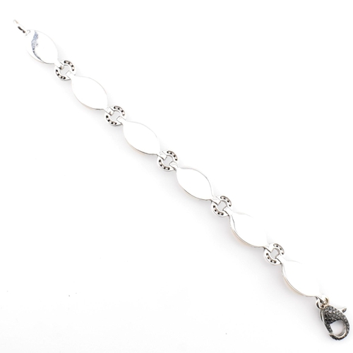 30 - An 18ct white gold, chalcedony and diamond panel bracelet. The 18ct white gold bracelet having point... 