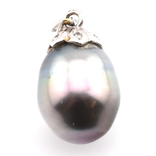 35 - An 18ct white gold, Tahitian pearl and diamond necklace pendant. The necklace pendant having an oval... 