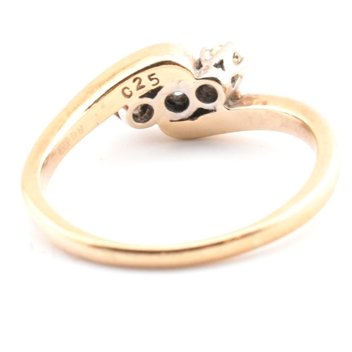 37 - A 9ct gold and diamond three stone crossover ring. The 9ct yellow gold ring having three round brill... 