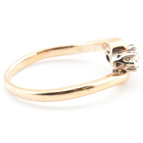 37 - A 9ct gold and diamond three stone crossover ring. The 9ct yellow gold ring having three round brill... 