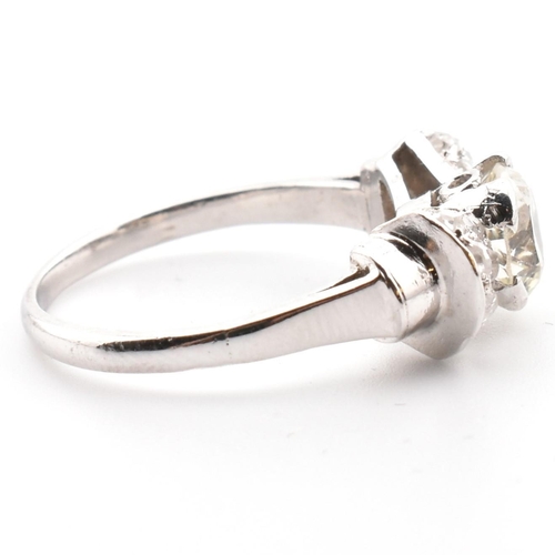 38 - A platinum Art Deco diamond ring. The antique ring in the form of a bow having a centre transitional... 