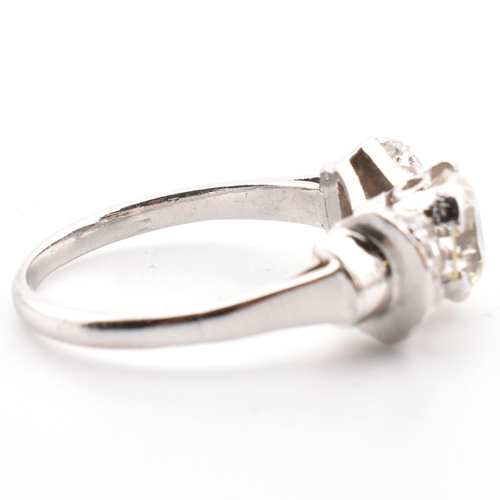 38 - A platinum Art Deco diamond ring. The antique ring in the form of a bow having a centre transitional... 