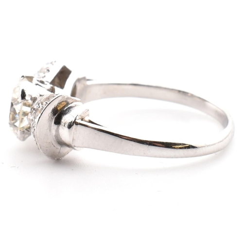 38 - A platinum Art Deco diamond ring. The antique ring in the form of a bow having a centre transitional... 