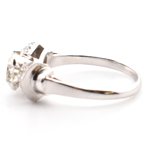 38 - A platinum Art Deco diamond ring. The antique ring in the form of a bow having a centre transitional... 