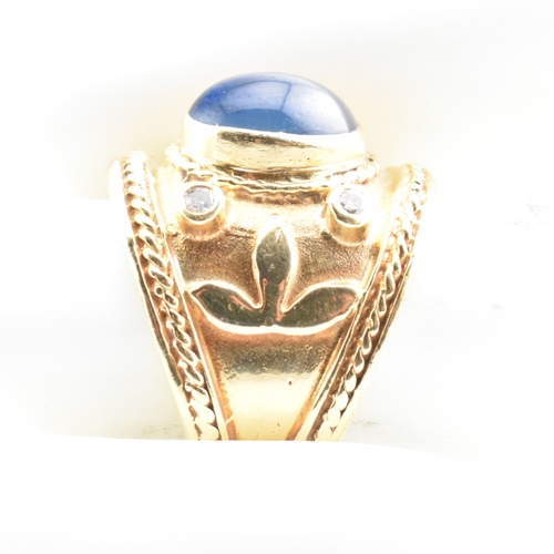 41 - An Etruscan style gold, sapphire and diamond band ring. The ring having a central collet set oval sa... 