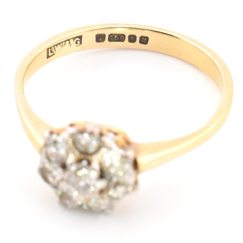 42 - A hallmarked 18ct gold and diamond cluster ring. The 18ct gold cluster ring having a central old cut... 