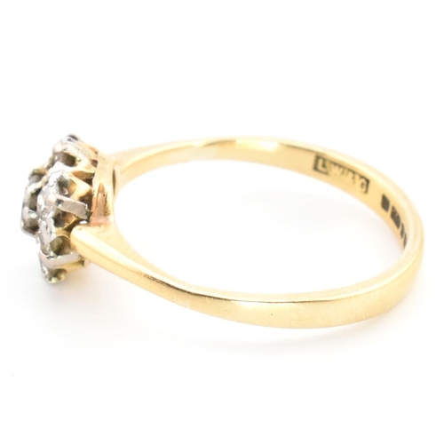 42 - A hallmarked 18ct gold and diamond cluster ring. The 18ct gold cluster ring having a central old cut... 