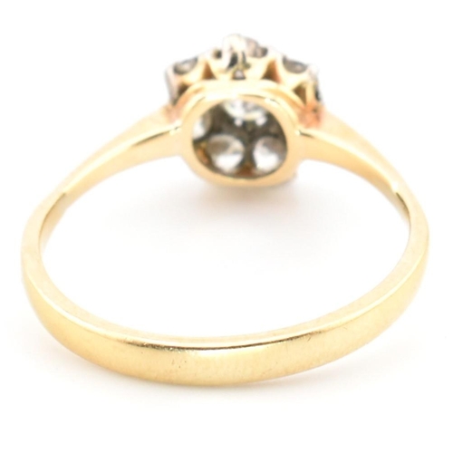 42 - A hallmarked 18ct gold and diamond cluster ring. The 18ct gold cluster ring having a central old cut... 