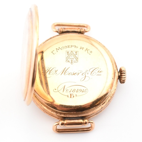 46A - A Henry Moser & Cie - Swiss 14k gold wristwatch. The watch with enamel Arabic dial signed Hy. Moser ... 