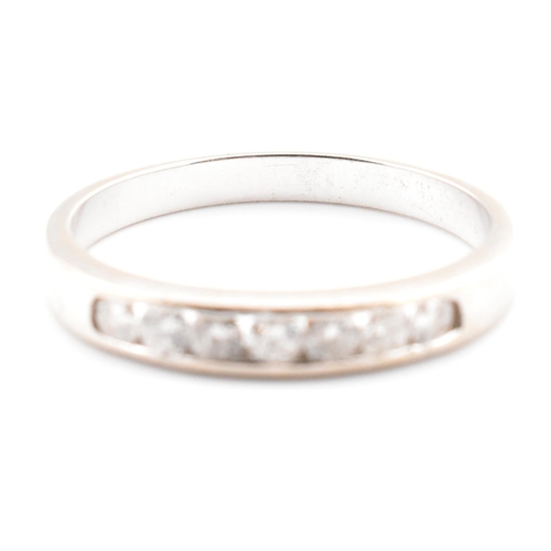 47 - A hallmarked 9ct white gold and diamond half eternity ring. The 9ct white gold ring having seven cha... 