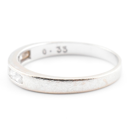 47 - A hallmarked 9ct white gold and diamond half eternity ring. The 9ct white gold ring having seven cha... 