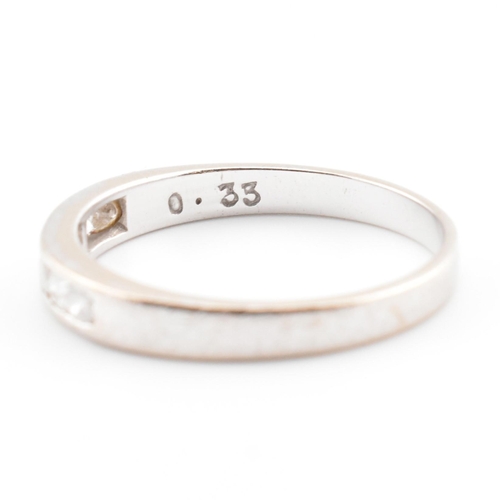 47 - A hallmarked 9ct white gold and diamond half eternity ring. The 9ct white gold ring having seven cha... 