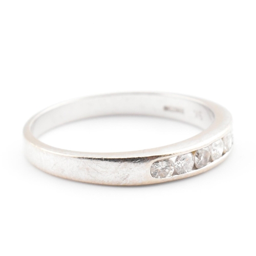 47 - A hallmarked 9ct white gold and diamond half eternity ring. The 9ct white gold ring having seven cha... 