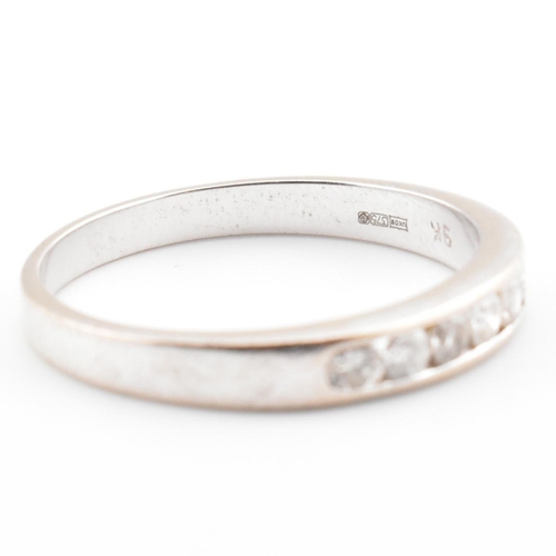 47 - A hallmarked 9ct white gold and diamond half eternity ring. The 9ct white gold ring having seven cha... 