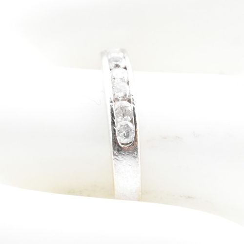 47 - A hallmarked 9ct white gold and diamond half eternity ring. The 9ct white gold ring having seven cha... 