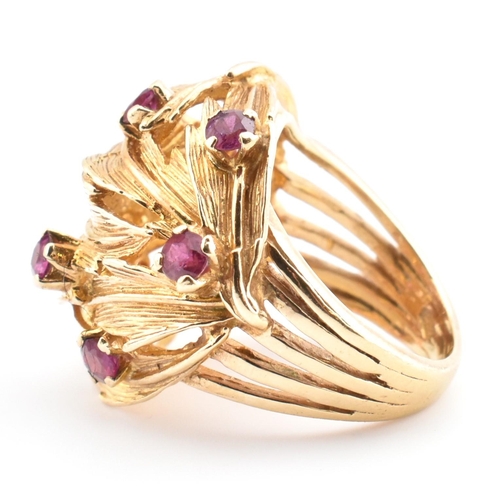 48 - A hallmarked 9ct gold and ruby leaf bombe ring. The hallmarked 9ct yellow gold ring of pierced, over... 