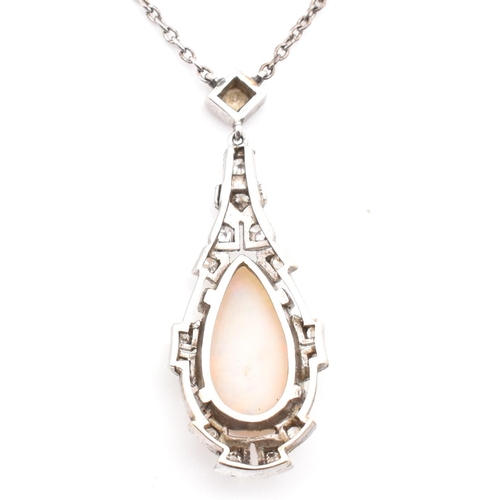 5 - A 1930s Art Deco white gold opal and diamond pendant necklace. The necklace strung with a pear cut o... 