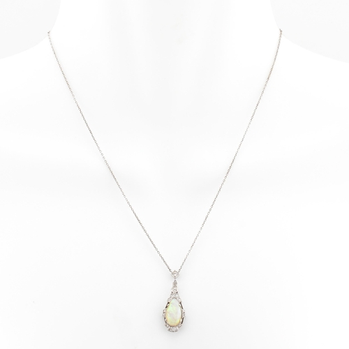 5 - A 1930s Art Deco white gold opal and diamond pendant necklace. The necklace strung with a pear cut o... 