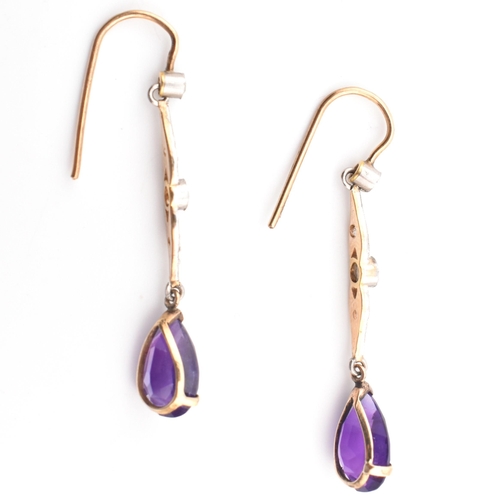 52 - A pair of Art Deco gold, amethyst and diamond pendant earrings. The pendant earrings having a pear c... 