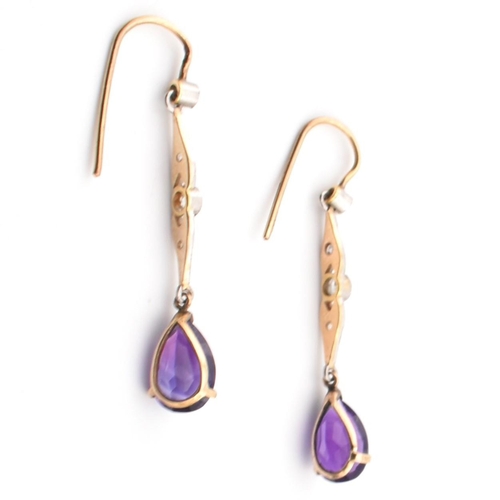 52 - A pair of Art Deco gold, amethyst and diamond pendant earrings. The pendant earrings having a pear c... 