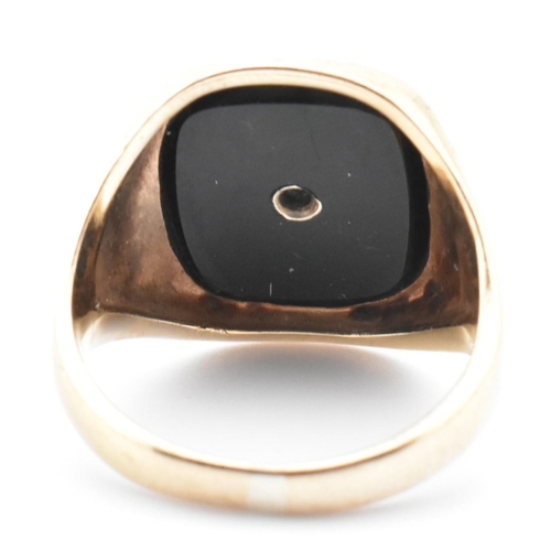 54 - A hallmarked 9ct gold onyx and diamond signet ring. The 9ct yellow gold signet ring having a rectang... 