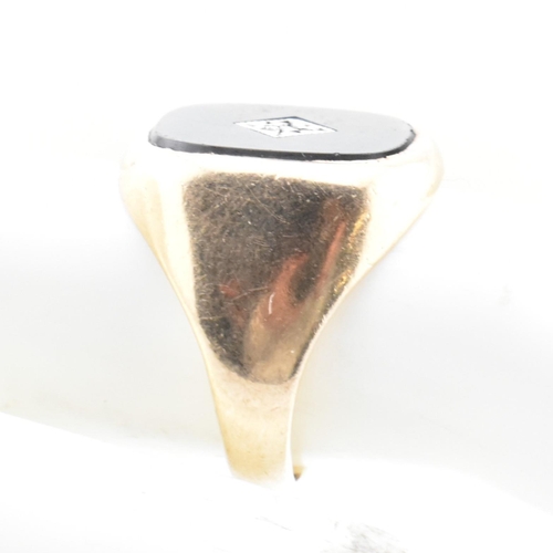 54 - A hallmarked 9ct gold onyx and diamond signet ring. The 9ct yellow gold signet ring having a rectang... 