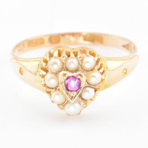 55 - A Victorian hallmarked 15ct gold, ruby and pearl heart ring. The ring set with a central round cut r... 