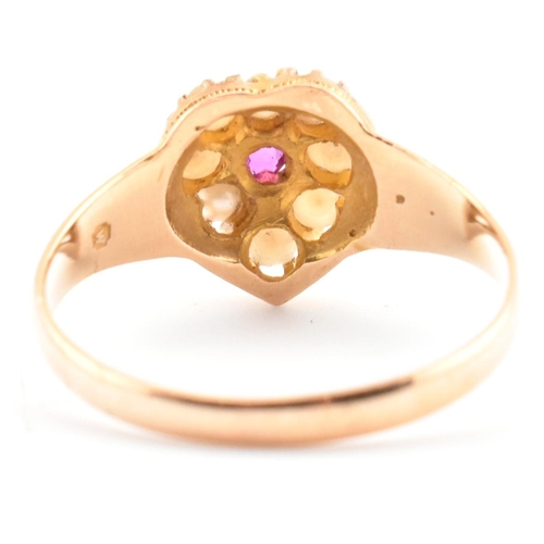 55 - A Victorian hallmarked 15ct gold, ruby and pearl heart ring. The ring set with a central round cut r... 