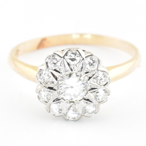 67 - A gold and diamond cluster ring. The ring having a central round brilliant cut diamond surrounded by... 