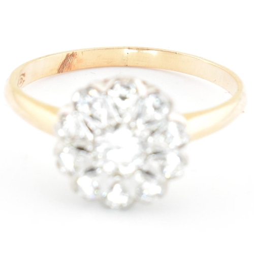 67 - A gold and diamond cluster ring. The ring having a central round brilliant cut diamond surrounded by... 