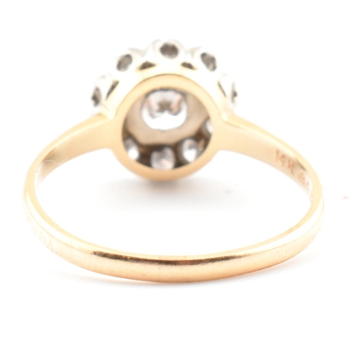 67 - A gold and diamond cluster ring. The ring having a central round brilliant cut diamond surrounded by... 