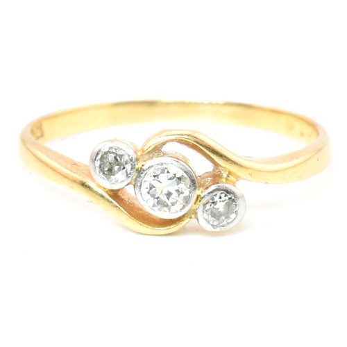 68 - A cased 18ct gold and diamond three stone crossover ring. The 18ct yellow gold ring having three gra... 