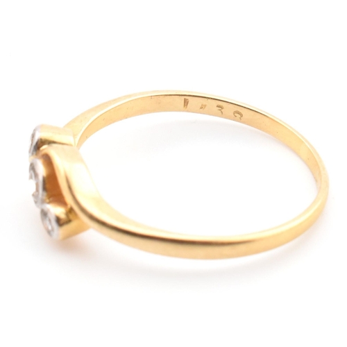 68 - A cased 18ct gold and diamond three stone crossover ring. The 18ct yellow gold ring having three gra... 