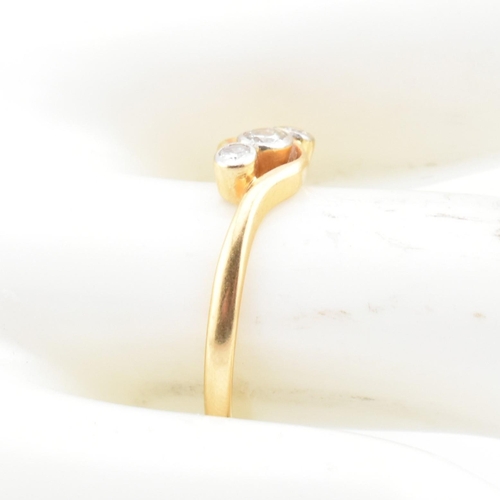 68 - A cased 18ct gold and diamond three stone crossover ring. The 18ct yellow gold ring having three gra... 