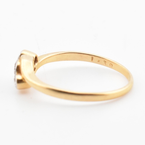 68 - A cased 18ct gold and diamond three stone crossover ring. The 18ct yellow gold ring having three gra... 