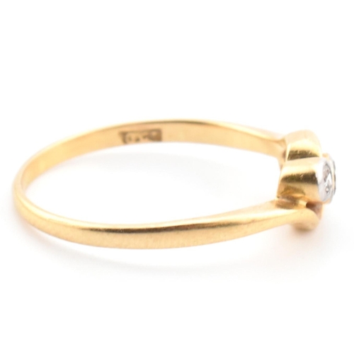 68 - A cased 18ct gold and diamond three stone crossover ring. The 18ct yellow gold ring having three gra... 