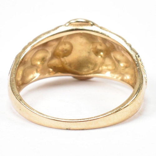 69 - A hallmarked 9ct gold buckle ring. The hallmarked gold ring having a central round buckle design to ... 