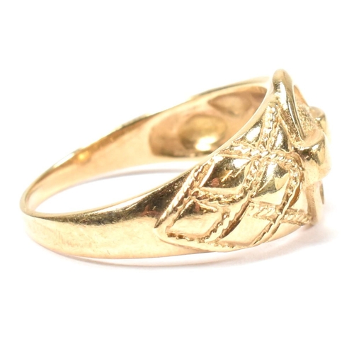 69 - A hallmarked 9ct gold buckle ring. The hallmarked gold ring having a central round buckle design to ... 