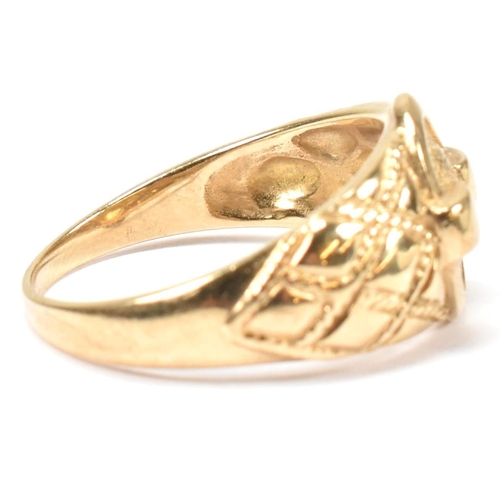 69 - A hallmarked 9ct gold buckle ring. The hallmarked gold ring having a central round buckle design to ... 