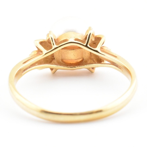 72 - An 18ct gold, cultured pearl and diamond dress ring. The 18ct yellow gold ring having a single semi-... 