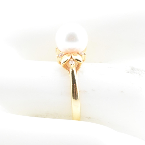 72 - An 18ct gold, cultured pearl and diamond dress ring. The 18ct yellow gold ring having a single semi-... 