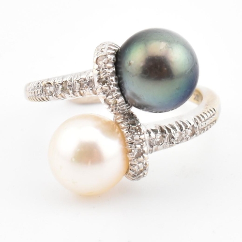 77 - An 18ct gold, cultured pearl and diamond crossover ring. The ring having two cultured pearls set in ... 