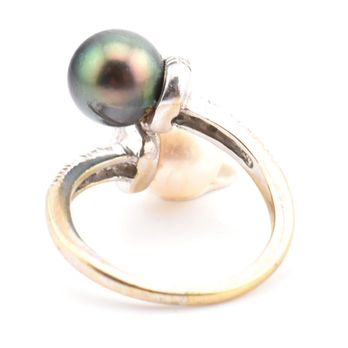 77 - An 18ct gold, cultured pearl and diamond crossover ring. The ring having two cultured pearls set in ... 