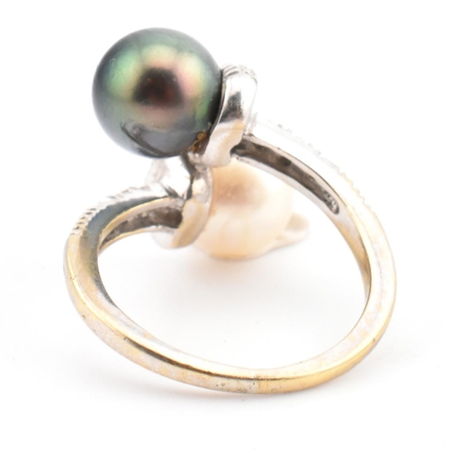 77 - An 18ct gold, cultured pearl and diamond crossover ring. The ring having two cultured pearls set in ... 